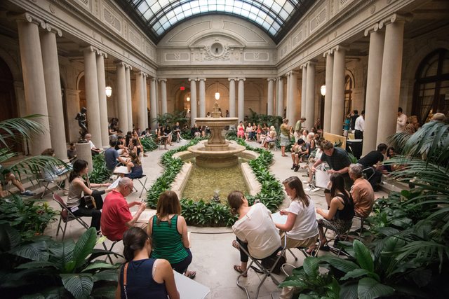 The Frick Collection atrium with people sitting around a water fountain
