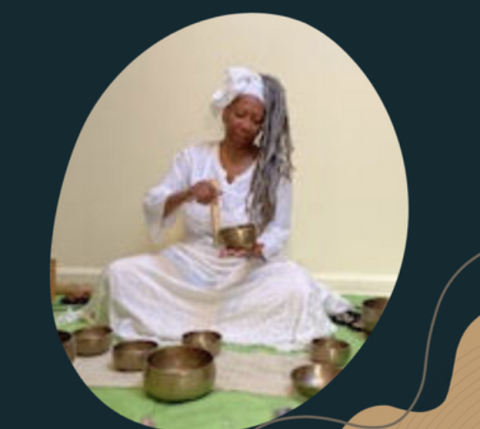 Beverly Aminata Spencer sitting, playing a singing bowl