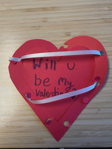 Red heart-shaped card with ribbons