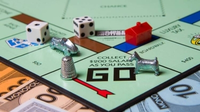 Corner of Monopoly board with dice and game pieces