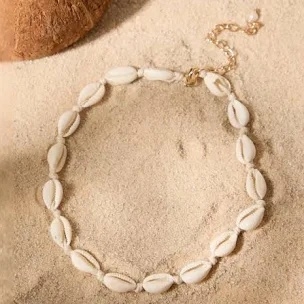 Puka shell necklace on sand